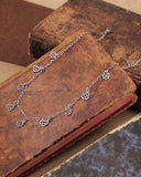 Collana girocollo 12 mini pendenti in acciaio - Cuore e fiore gotico