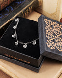 Collana girocollo 12 mini pendenti in acciaio - Cuore e fiore gotico